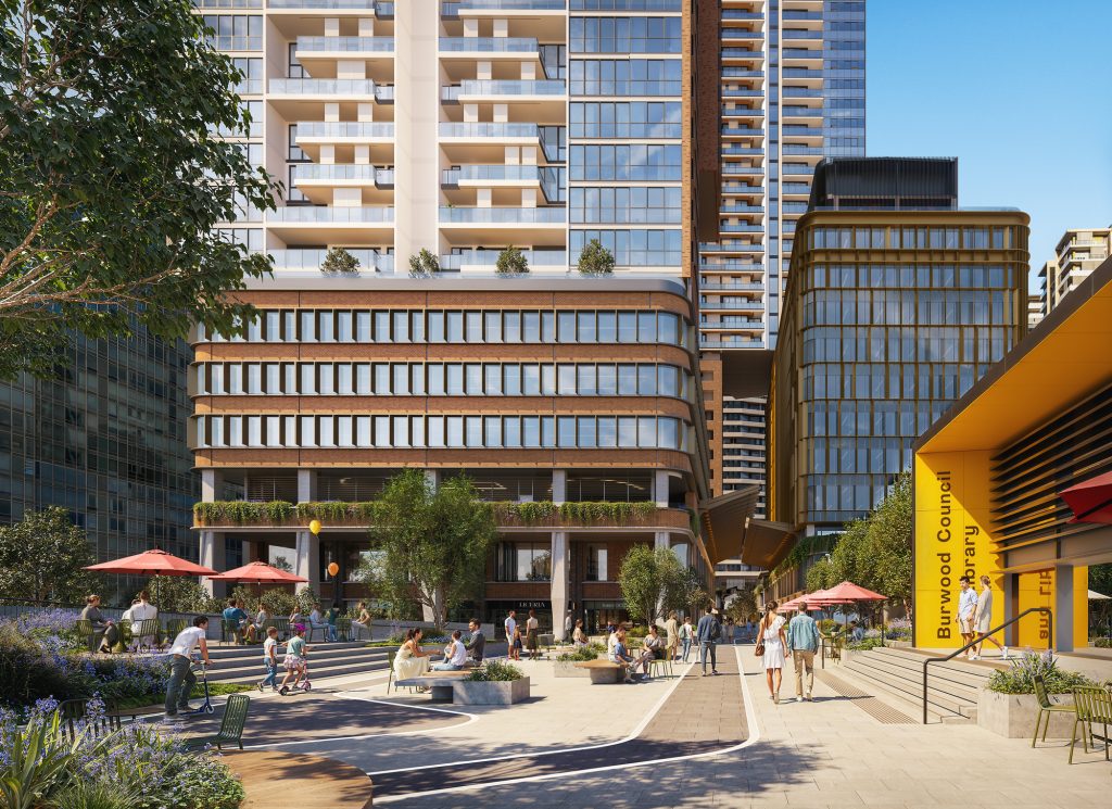 Wide street view of Burwood Place, capturing the scale of the towers and their position within Burwood town centre.